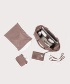 Set of brown bags and accessories on a light gray background