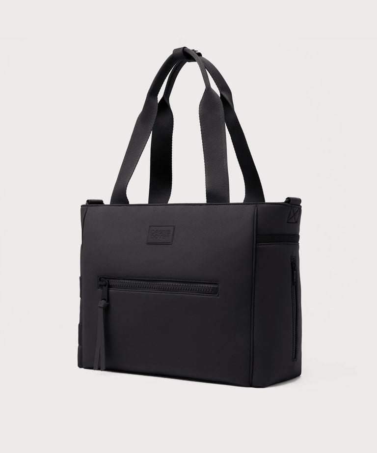 Black tote bag with a visible brand logo on a light gray background