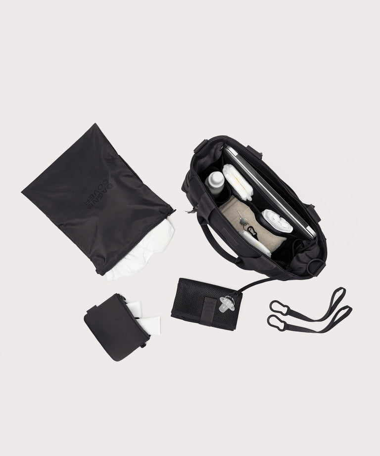 Collection of black travel accessories including a bag, wallet, and pouch on a light gray background