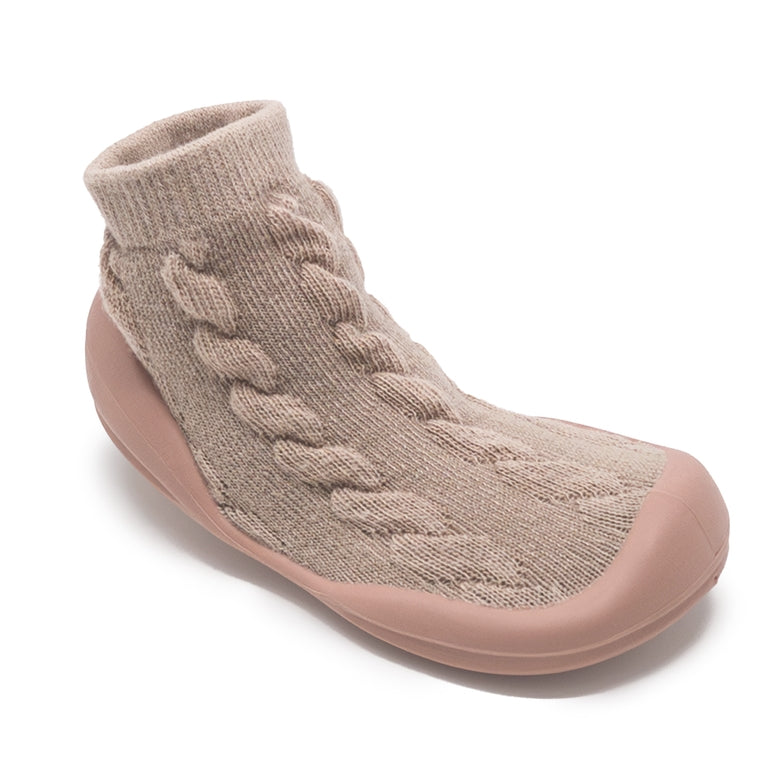 A single slip-on knit sock bootie in a dusty taupe-beige color, featuring a textured cable-knit pattern on the upper and a smooth matching sole, shown on a white background.