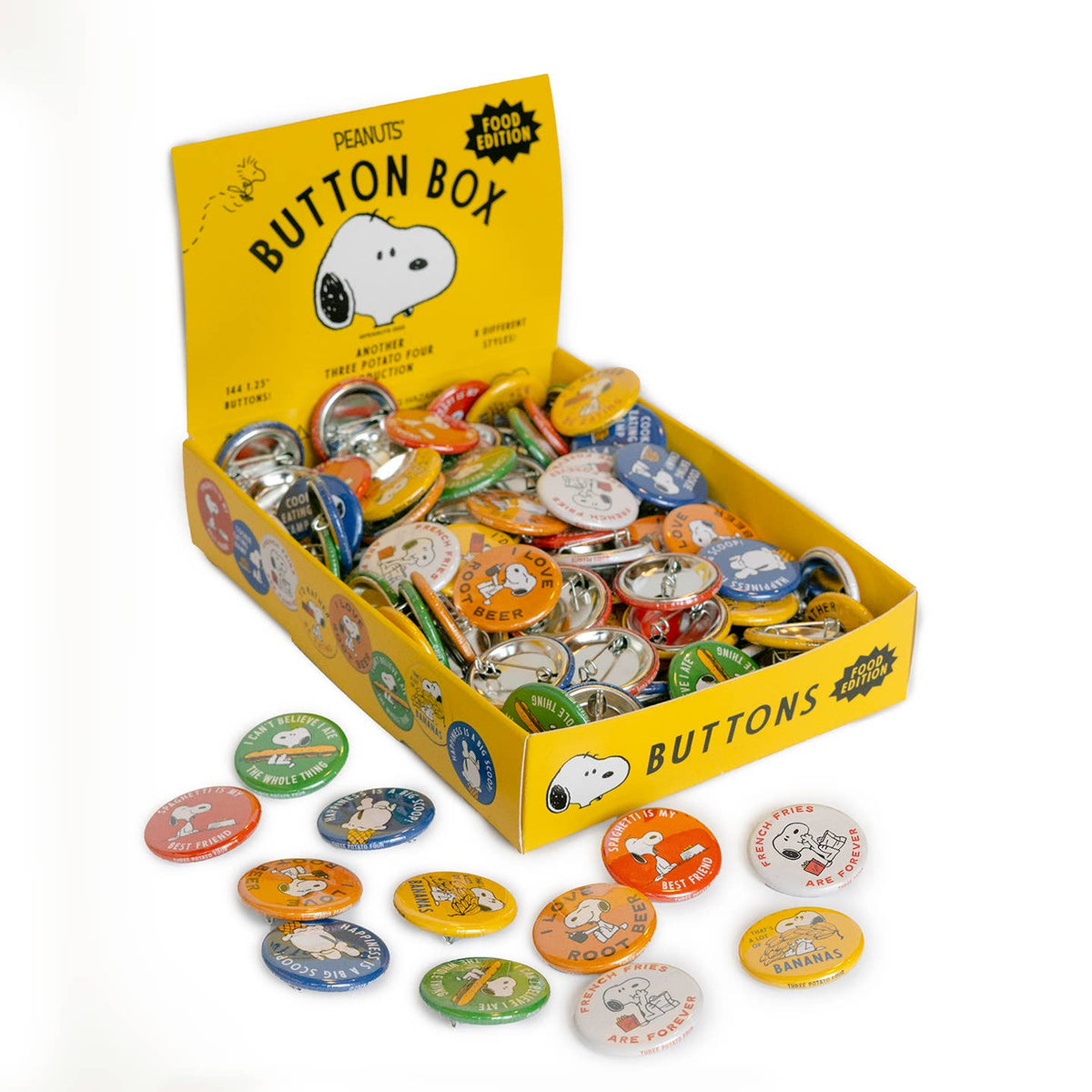 Box of Peanuts button collection with various buttons displayed on a white background