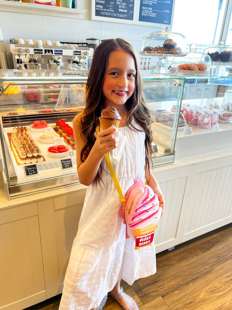 Young girl holding an ice cream cone in a dessert shop