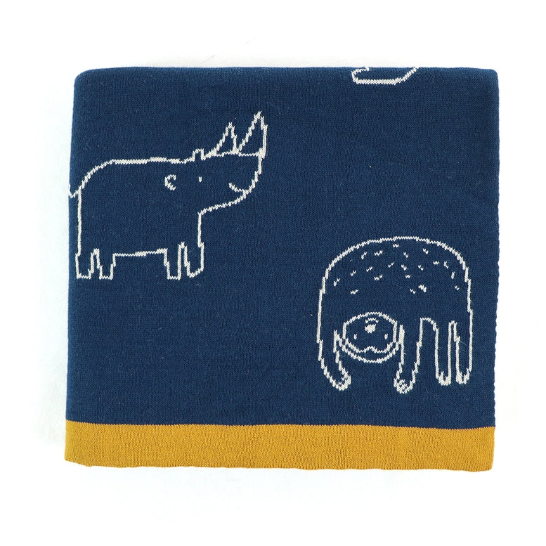 A folded navy blue towel with white embroidered animal motifs, including a rhinoceros and an elephant, and a mustard yellow border along the bottom edge.