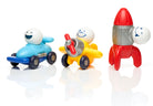 Three colorful plastic toy vehicles with smiling cartoon faces: a blue race car, a yellow airplane, and a red rocket ship, arranged on a white reflective surface against a white background.