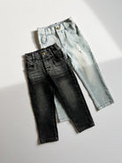 Two pairs of jeans, one black and one light blue, on a white background