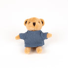 A small plush teddy bear with tan fur wearing a blue knit sweater, photographed against a plain white background.