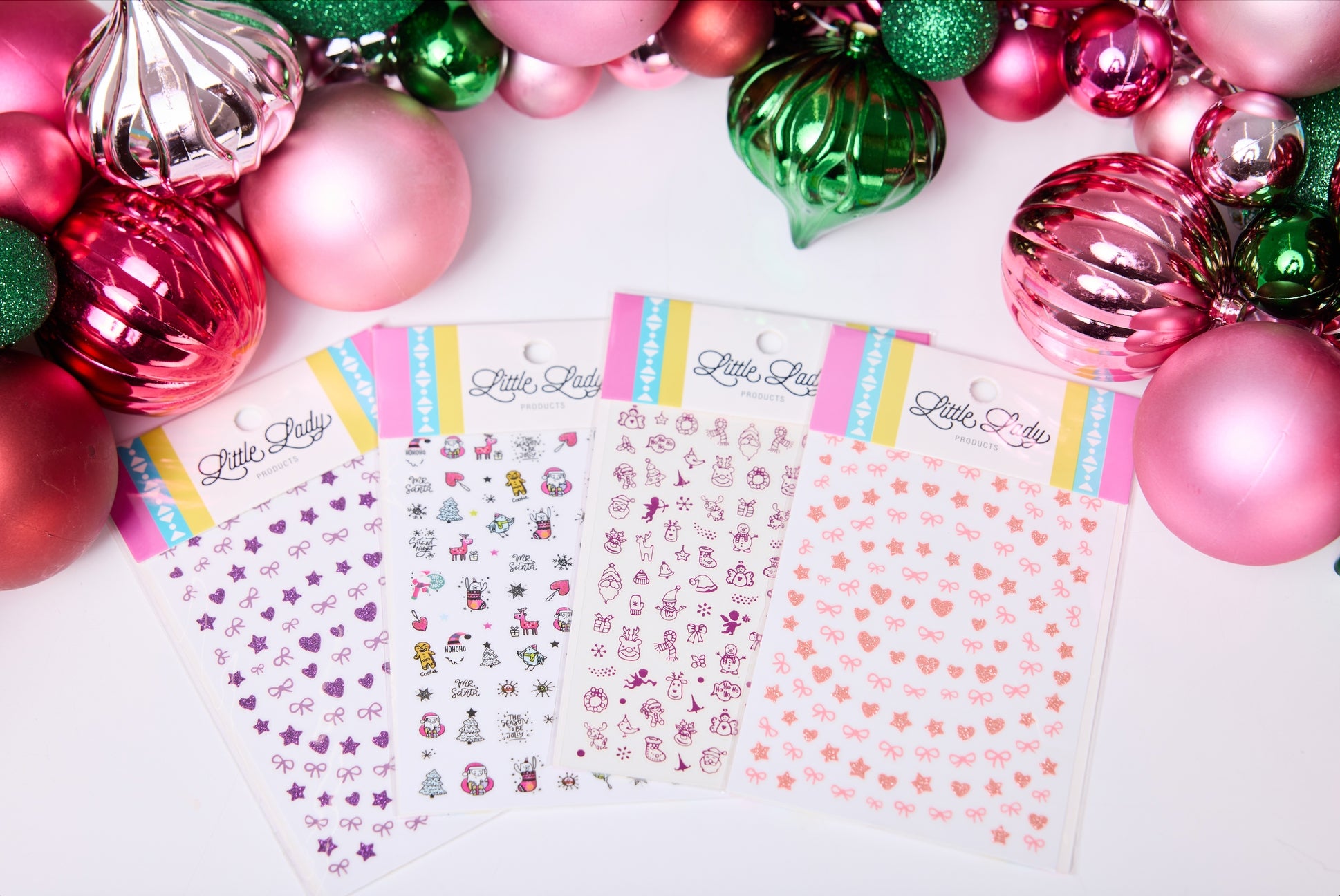 Sheet of decorative stickers with colorful border on a white background surrounded by Christmas ornaments.
