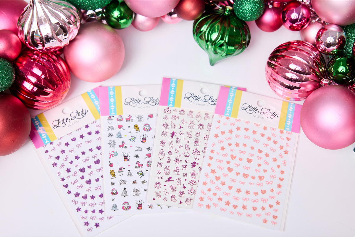 Sheet of decorative stickers with colorful border on a white background surrounded by Christmas ornaments.