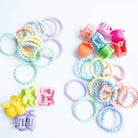 Colorful hair ties and clips on a white background