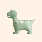 Green dinosaur-shaped night light on a beige background