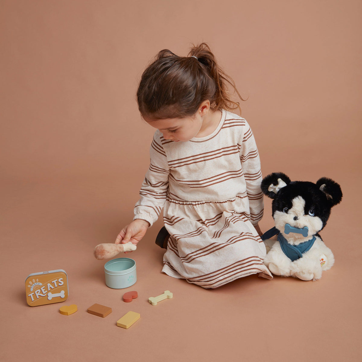 Child playing with toys on a brown background