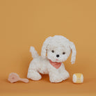 White plush dog toy with a pink bow tie on an orange background