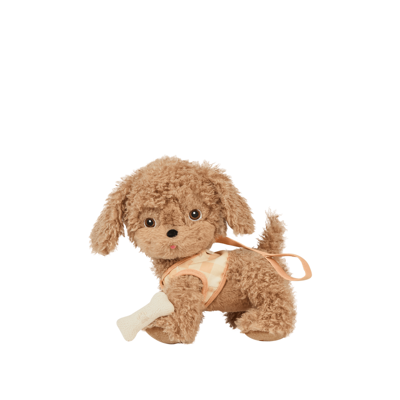 Plush toy dog with a bandage on a white background