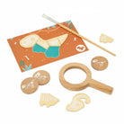 A children's paleontology and fossil identification toy set on a white background, including wooden fossil pieces, a magnifying glass, a paintbrush, a discovery sheet, and circular fossil-identification discs.