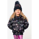 Child wearing a black puffer jacket with colorful heart patterns and a matching hat on a white background