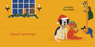 An interior illustration from Dog's First Christmas featuring a warm mustard-yellow room with a snowy window scene on the wall. A white dog wearing a Santa hat and blue bandana sits next to a smiling baby in a red elf costume holding a small gift. Text near the top right reads, "I am Dog. This is Baby."