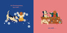 An interior spread from Dog's First Christmas featuring a split background of deep blue on the left and coral pink on the right. On the blue page, text at the top reads "At Christmastime, we craft..." while a white dog and a smaller dog stand amidst swirling paper snowflakes and a gingerbread figure. On the pink page, a table is piled with craft supplies, holiday cookies, and decorations, accompanied by text at the bottom that reads "...we cook...