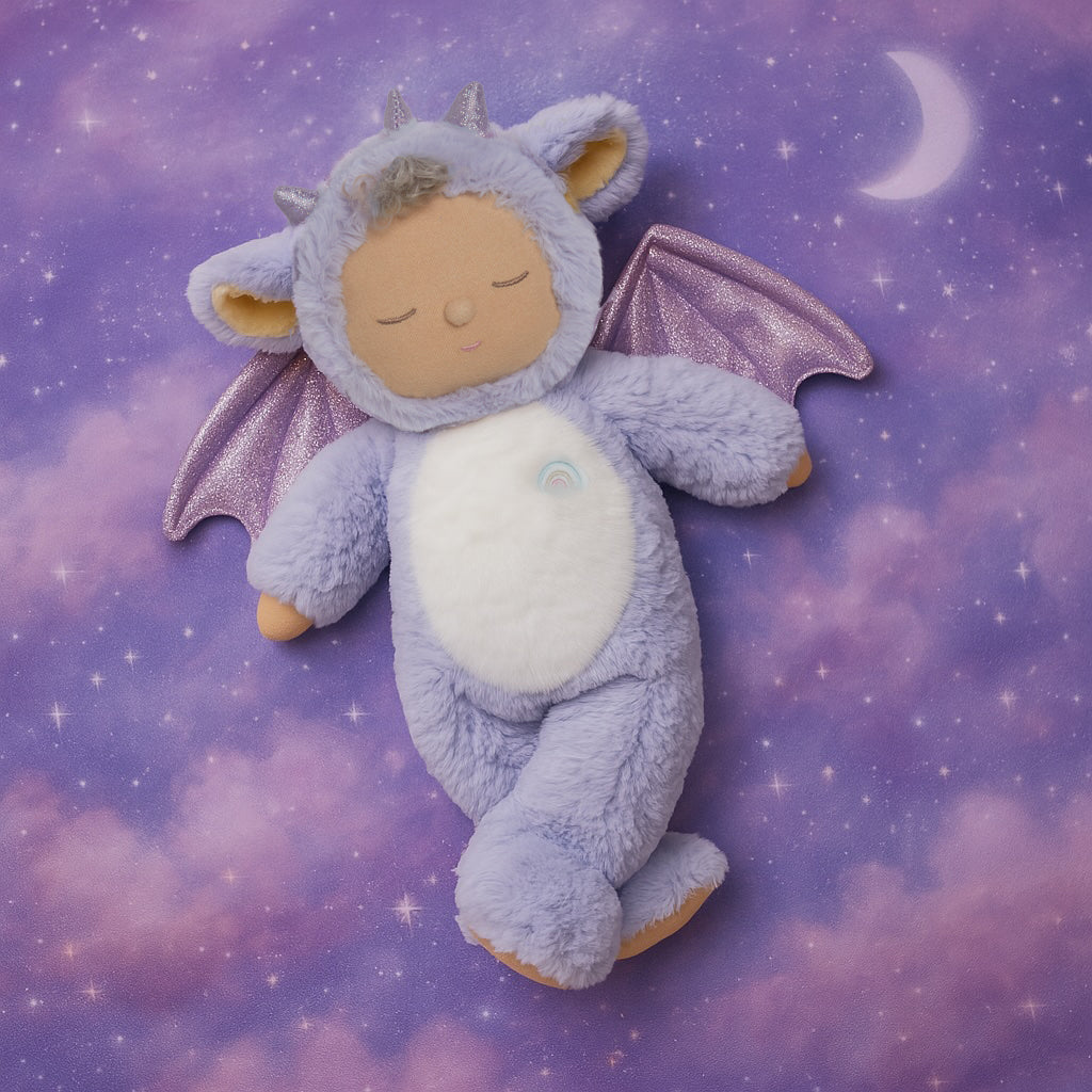 Plush toy dragon with closed eyes on a purple cloud background