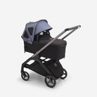 Black stroller with a gray canopy on a white background