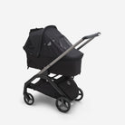 Black stroller with a gray handle on a white background