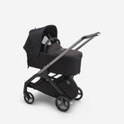 Black stroller with a matching bassinet on a white background