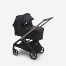 Black stroller with canopy on a white background