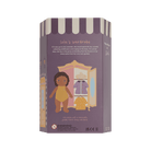 Box packaging for a doll with a wardrobe illustration on a green background
