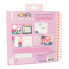 Pink activity book with colorful illustrations and text on a white background