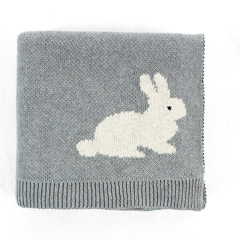 A folded gray knit blanket featuring a white knitted rabbit motif and a ribbed hem, shown on a plain white background.