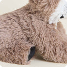 A close-up view of the Raccoon Junior by Warmies plush toy, highlighting its textured brown and white fuzzy fur.