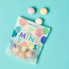 Dabble & Darlap Mini Drops bath bombs on a light blue background