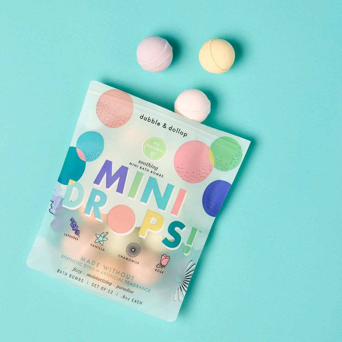 Dabble & Darlap Mini Drops bath bombs on a light blue background