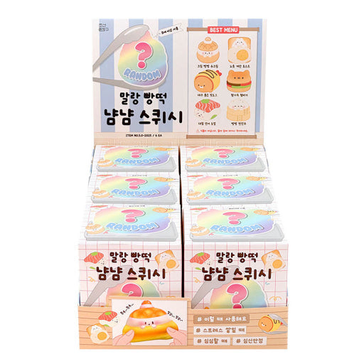 A display of cute, pastel-colored blind box products with Korean text, alongside a large yellow and orange character toy with a rainbow pattern, all on a clean white background.
