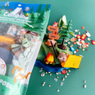 Camping-themed play dough set with packaging on a green background