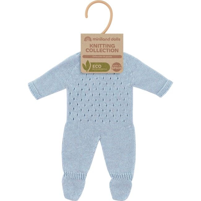 A light blue hand-knit baby jumpsuit for doll with a textured openwork pattern on the chest, raglan sleeves, and ribbed cuffs on the legs, shown against a plain white background with craft paper tag and clothing hanger.