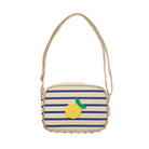 A small crossbody bag with navy blue and cream horizontal stripes, featuring a yellow and green textured lemon applique on the front and a thin beige shoulder strap.