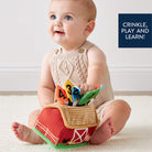 Baby playing with a colorful educational toy on a light background
