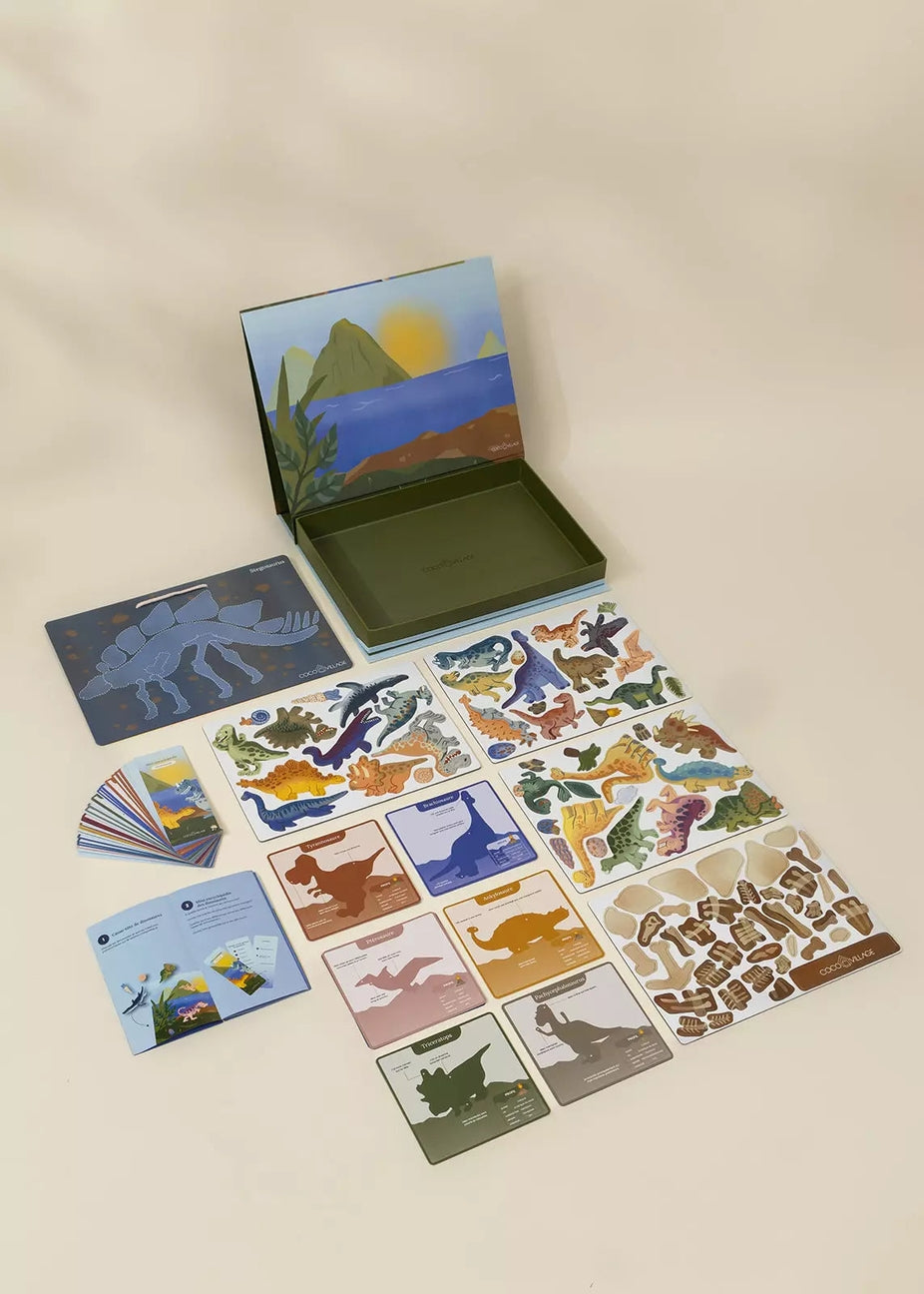 Set of dinosaur-themed cards and stickers on a beige background