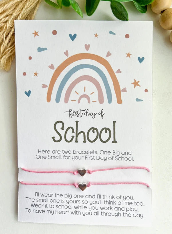 Card with rainbow design and bracelets for the first day of school, featuring a heart message.