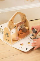 Wooden toy set with ice cream truck and mouse figures on a wooden floor.
