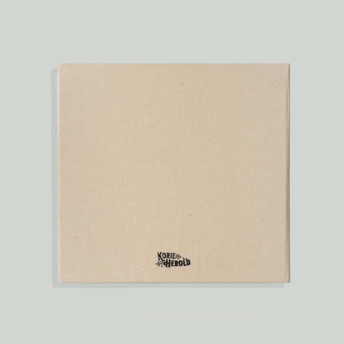 Beige fabric panel with a brand logo on a light gray background