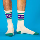 White socks with purple and green stripes labeled 'MAMA' on a blue background