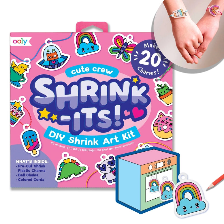 Oooy cute crew Shrink-Its! DIY Shrink Art Kit packaging shown on a white background, with a small illustrated shrink machine, a charm, and a pencil. A circular inset at top right shows two hands wearing colorful wrist charms.