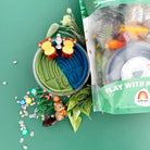 Playset with small animals and nature elements on a green background