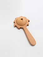 Wooden lion-shaped rattle on a white background