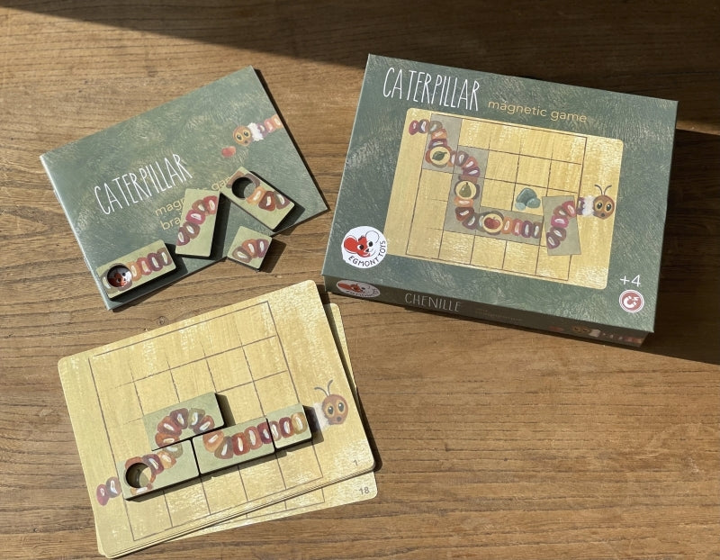 Caterpillar magnetic game set on a wooden surface