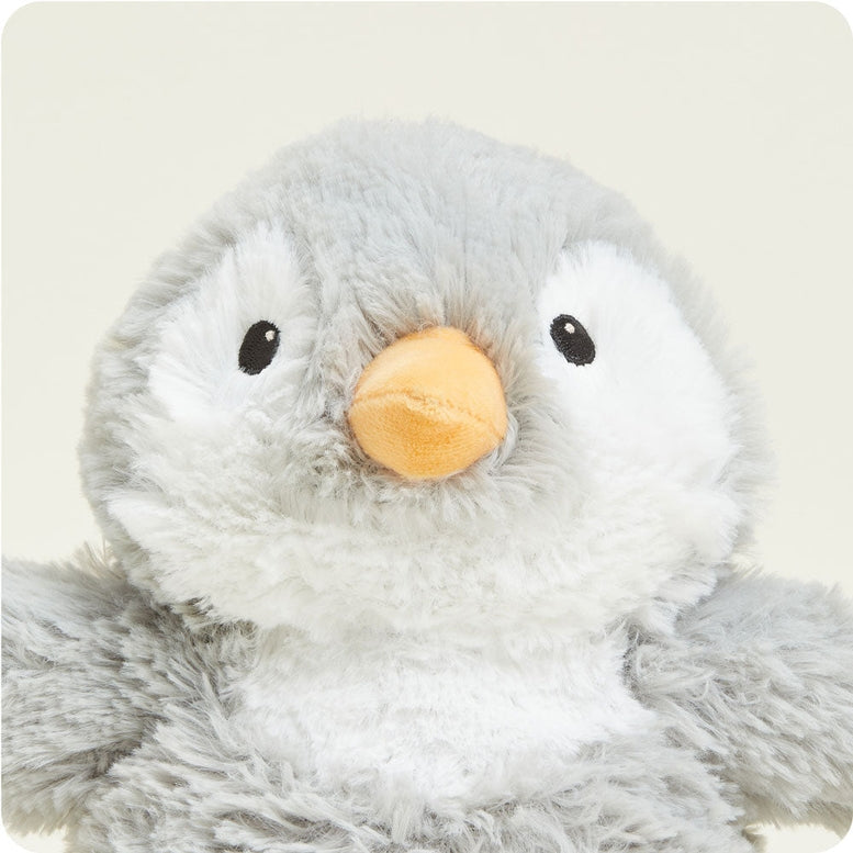 Close-up of the textured gray and white plush fabric and black eye of the Gray Penguin by Warmies stuffed animal.