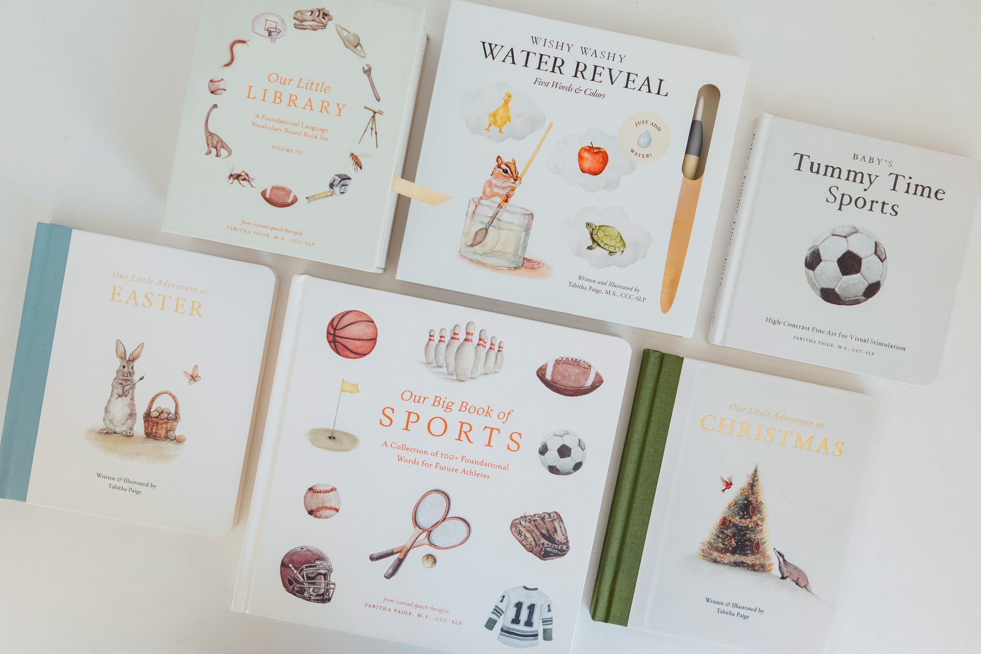 Collection of children's books on a white surface