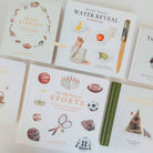 A set of children's illustrated books arranged in a flat lay on a white background. Visible titles include Our Little Library, Wishy Washy Water Reveal, Our Big Book of Sports, and Our Little Adventure Christmas.