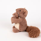 Stuffed animal beaver holding a smaller beaver toy on a white background